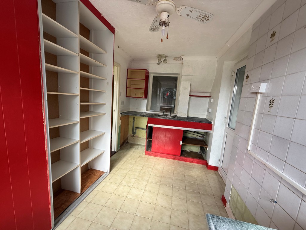 Lot: 163 - THREE-BEDROOM DETACHED HOUSE FOR IMPROVEMENT - Alternative view of tiled kitchen with cupboards